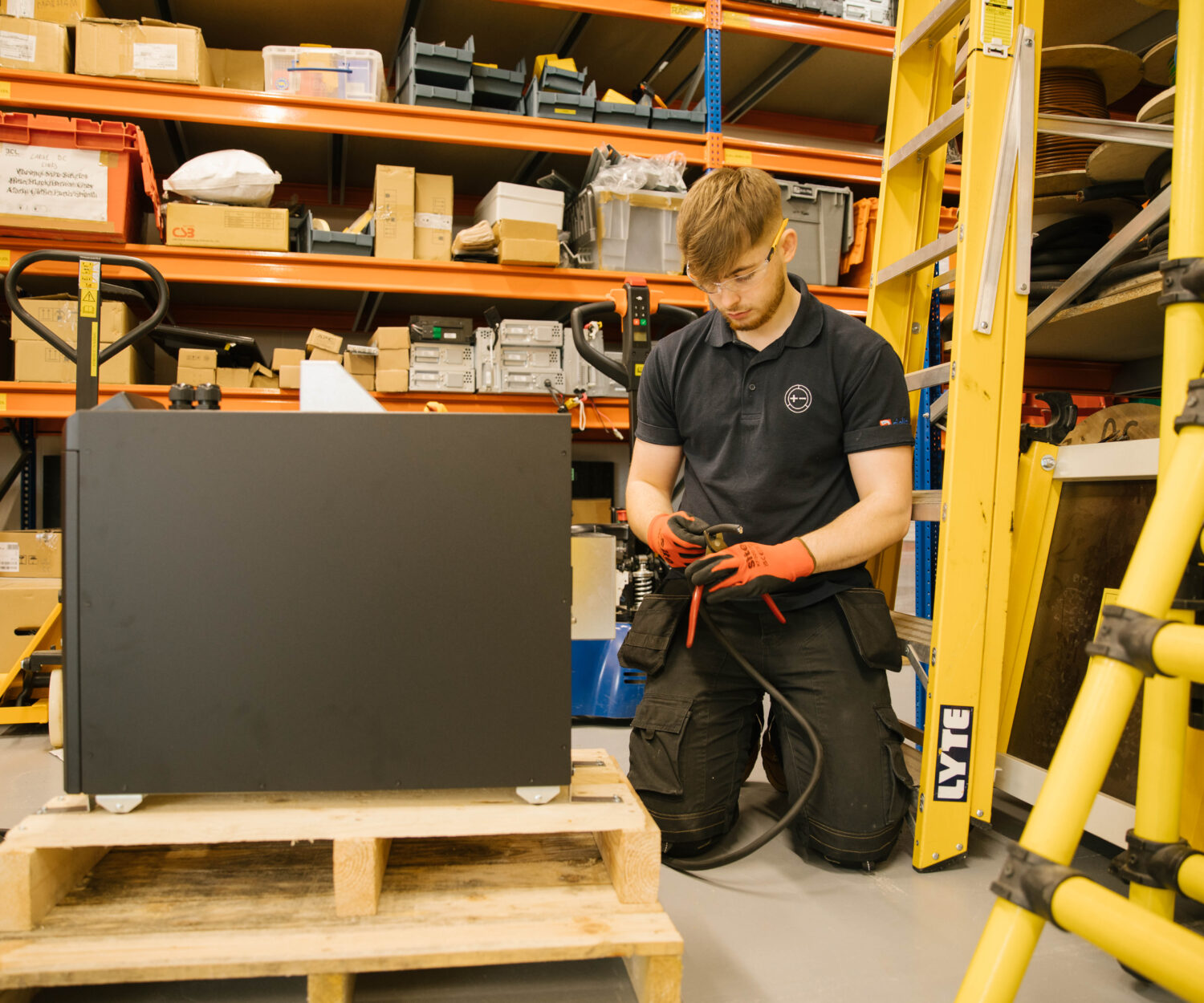 Man kneeling working on battery power